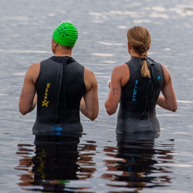 Back view of two people standing in water